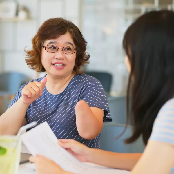 Disabled woman amputee talking to plan manager