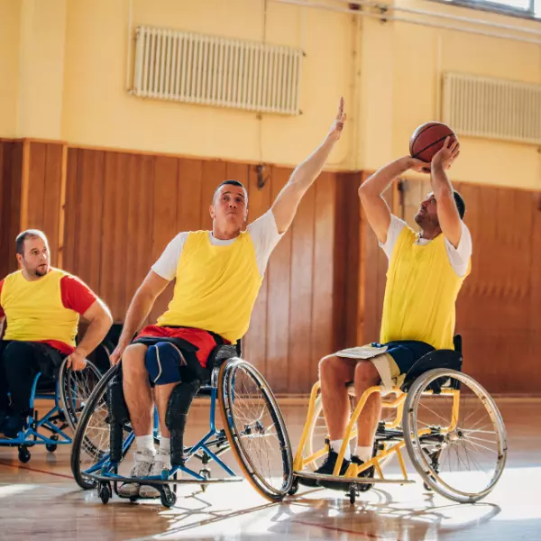 Men in wheelchairs playing indoor basketball